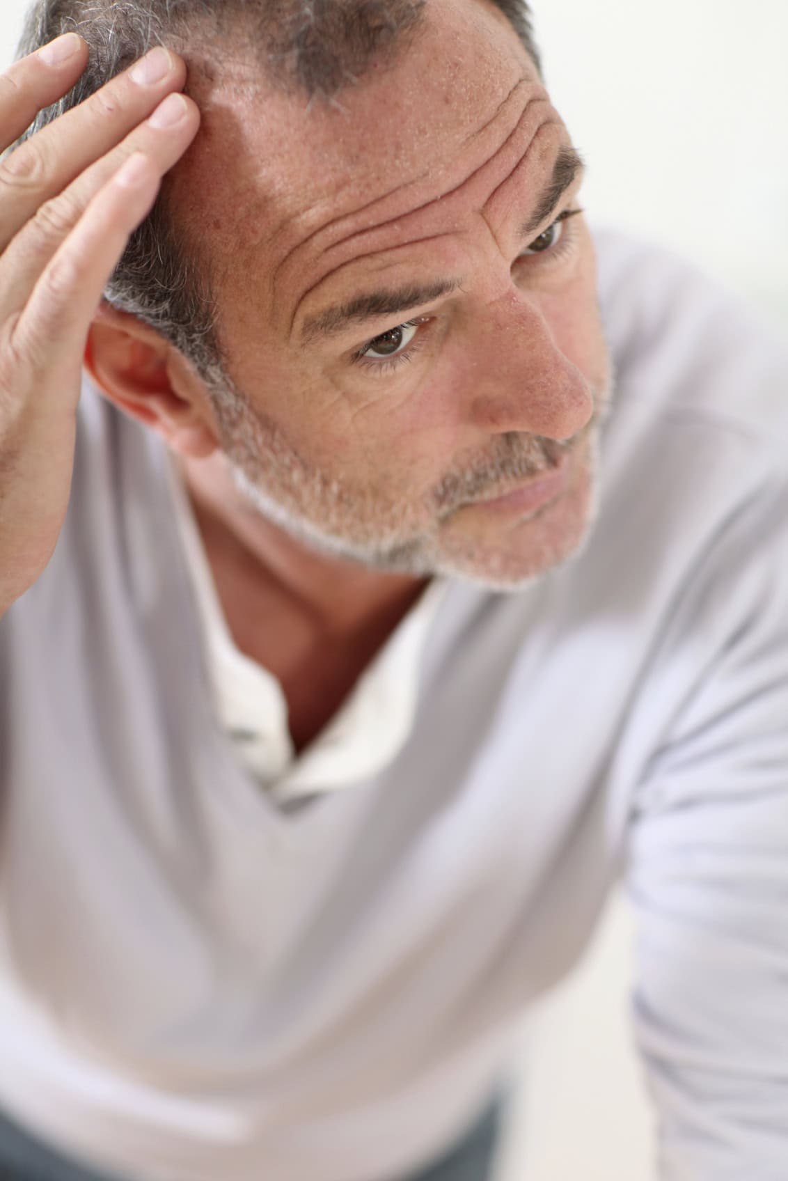 Man checking his hairline in the mirror